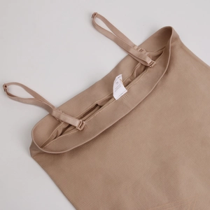 Detail of adjustable straps and ribbed fabric on a seamless nude bodysuit for women