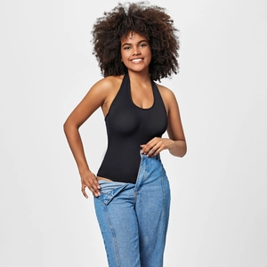 Detailed view of a black halter neck bodysuit paired with jeans in a studio setting