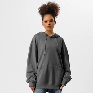Detail view of deep grey oversized hoodie featuring a drawstring hood and kangaroo pocket