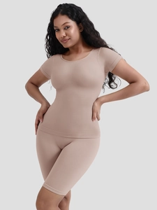 Detail of nude seamless shapewear set featuring crew neck top and high-waist shorts