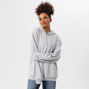 Detail of grey oversized hoodie showing soft cotton texture and classic kangaroo pocket
