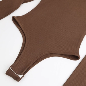 Detailed macro shot of ribbed brown bodysuit showing texture and snap button closure