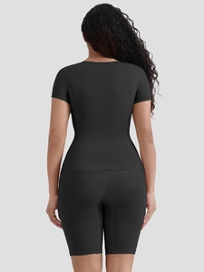 Back view of high-elastic black yoga set featuring short sleeve top and cycling shorts