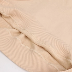 Macro shot of ribbed cuffs and soft fleece lining of this beige oversized cotton hoodie