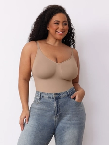 Detail of nude seamless bodysuit with V-neck and thin straps worn with blue jeans