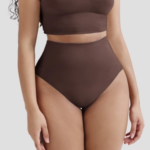 Close-up of seamless ribbed high-waisted shaper thong and crop top set in dark brown