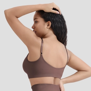 Detail view of seamless dark brown sports bra with adjustable straps and U-shaped back