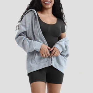 Detail of grey hooded zip-up sweatshirt with spacious pockets and athletic design