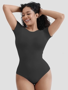 Detail showing the seamless ribbed texture of the black short sleeve shaping bodysuit