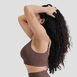Detail of coffee brown seamless sports bra featuring ribbed side support and elastic fabric
