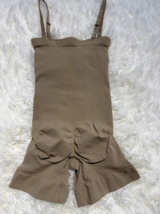 Detail of coffee brown seamless shapewear bodysuit with tummy control and butt lifting texture