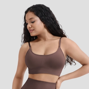 Detail of seamless dark coffee sports bra featuring ribbed hem and fine shoulder straps