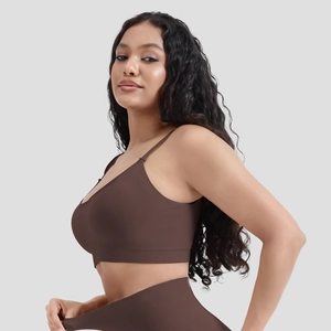 Detail of dark brown seamless ribbed sports bra with removable pads and slim fit