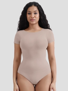 Macro detail of seamless beige shapewear bodysuit with compressive ribbed texture