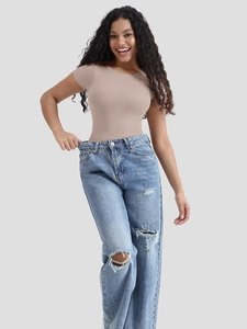 Macro detail of seamless nude compression bodysuit with high-waist vintage ripped jeans