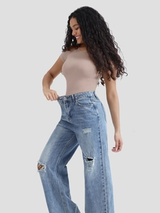 Close-up of high-waist wide-leg distressed blue jeans with vintage washed denim details