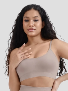 Detail of seamless ribbed sports bra with wide elastic band in light khaki color