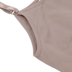 Detail of adjustable straps and reinforced stitching on a dusty pink slimming vest
