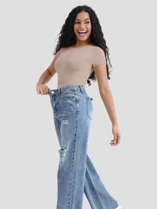 Detail of high-waisted distressed jeans paired with a slim-fit light brown short sleeve top