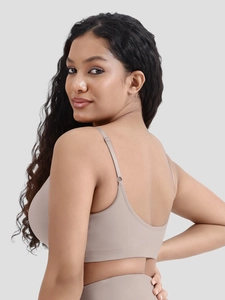 Detailed side view of nude seamless ribbed bra with adjustable straps and wide support band