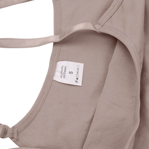 Detail showing garment care label with 85% polyamide and 15% elastane material content
