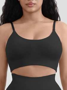 Detail of black seamless ribbed sports vest with removable pads and matching shorts