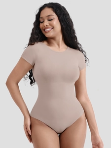 Detail of nude short sleeve bodysuit with ribbed texture and slim fit compression