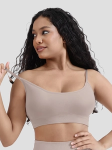 Detailed close-up of seamless nude sports bra with ribbed texture and elastic fabric