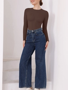Detail of a brown long sleeve slimming bodysuit paired with high waist wide leg blue jeans