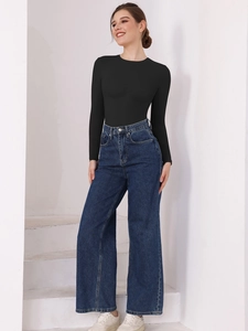 Slim fit black long sleeve bodysuit styled with high-waist jeans on a white staircase