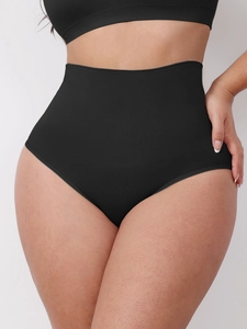 Detail of high-waist black shaping panties showing seamless ribbed texture and tummy control