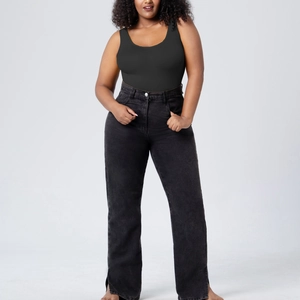 Sleeveless slimming bodysuit paired with black high-waisted wide-leg side-slit jeans