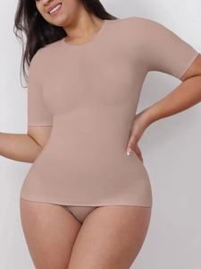 Close-up of nude seamless compression shapewear top with short sleeves and round neck