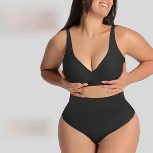 Detail of black seamless plus size bra and high waist panties on model with V-neck