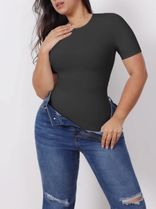 Close-up of slim-fit black short-sleeve bodysuit paired with distressed blue jeans