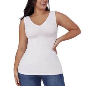 White V-neck seamless slimming bodysuit top paired with blue jeans in a studio setting