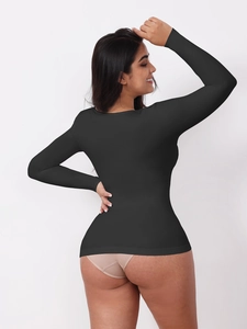 Detail view of the seamless back tailoring on this black long sleeve compression bodysuit
