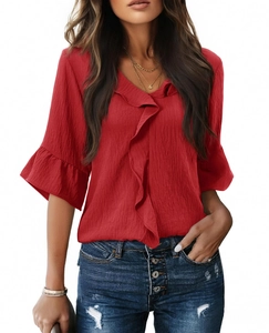 Detail of red V-neck top showing 3/4 ruffles bell sleeves and textured vertical pleats
