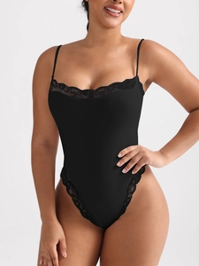 Close-up of black lace bodysuit featuring thin straps and delicate floral embroidery detail