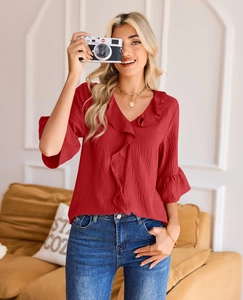 Detail of elegant V-neckline with ruffle trim and textured dark red fabric for women