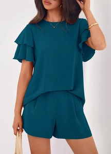 Close-up of summer two-piece outfit showing teal double-layered ruffle sleeves and crepe texture