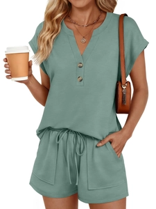 Detail view of sage green V-neck lounge set with wooden buttons and drawstring shorts