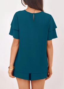Detail of the back opening button and double-layer ruffle sleeves on the teal textured set