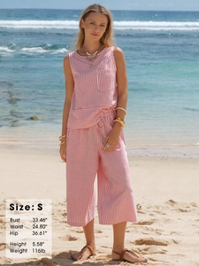 Detailed beach view of a red and white striped two-piece set with sizing information