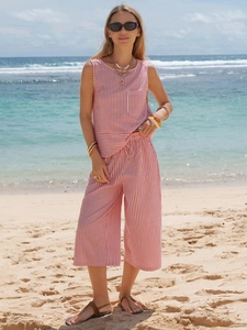 Detail of red and white striped cotton two-piece set featuring a drawstring waist and pocket