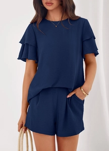 Detail of dark blue summer set showing double-layered ruffle sleeves and premium fabric texture