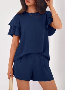 Detail of the layered ruffle sleeve and navy blue crepe fabric on this summer two-piece set