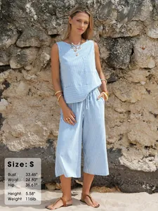 Detailed size chart with model measurements for blue and white striped summer outfit