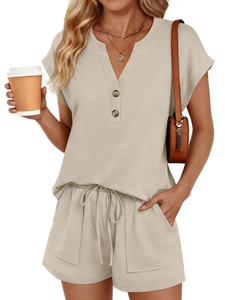Detail view of beige knit two-piece set featuring V-neck top with buttons and drawstring shorts
