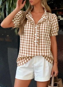 Detail view of brown gingham short sleeve shirt with ruffle collar and white buttons